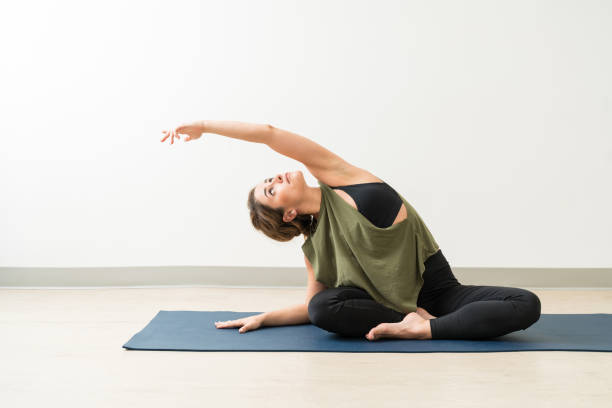 istock Beautiful Fit Lady Stretching Herself Sideways At Fitness Studio 1168077227