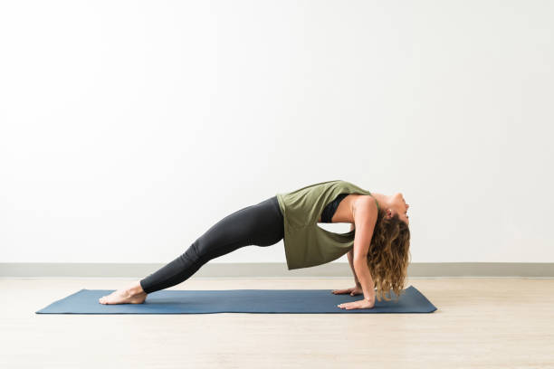 istock Side View Of Young Female Training In Core Strength 1168078438