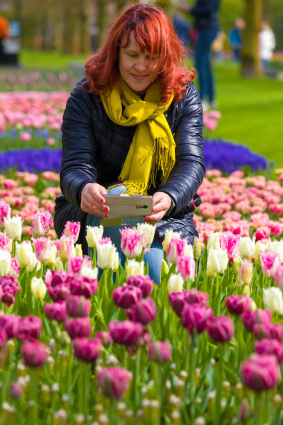 istock Woman near blooming tulips 1168079156