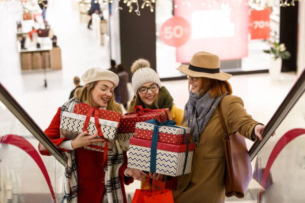 istock Mother and daughters with presents at the mall 1168079206
