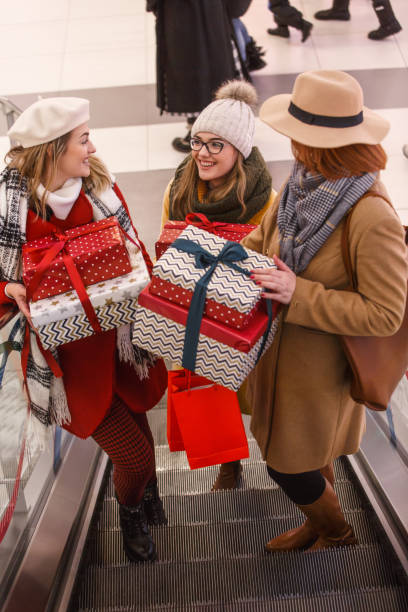 istock Mother and daughters with presents at the mall 1168079210