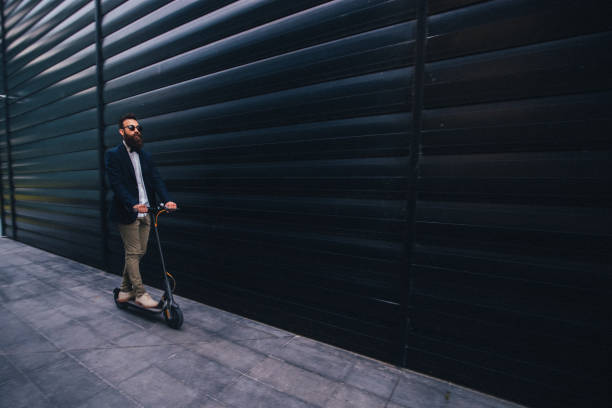 istock Hipster businessman riding an electric scooter 1168079296
