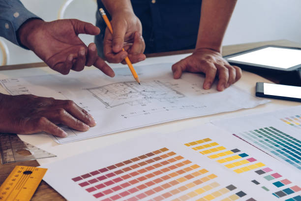 istock architect interior designer working with house drawing plan & color swatch 1168080187