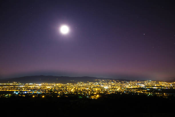istock View of city lights and night sky. 1168084398