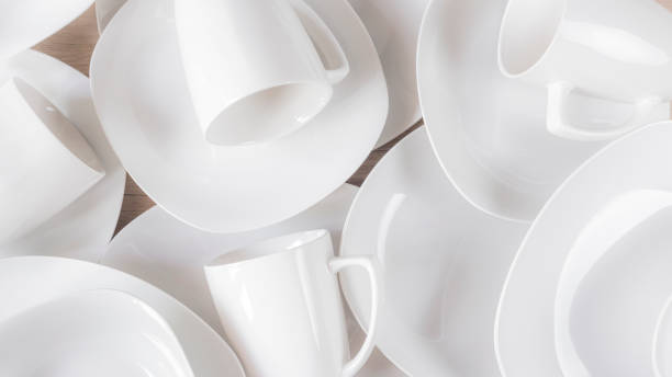 istock White ceramic cups and plates on wooden background, image 1168084449