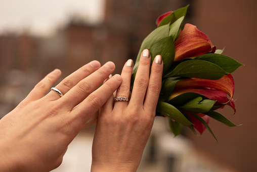 Hands of a newly married couple showing their rings in a roof top in the Upper East side of Manhattan (NYC, USA)