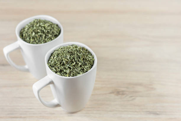 istock white cup with moringa leaves on wooden background 1168086397