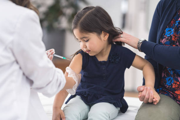 istock Young ethnic girl at the doctor's office getting a shot 1168087252