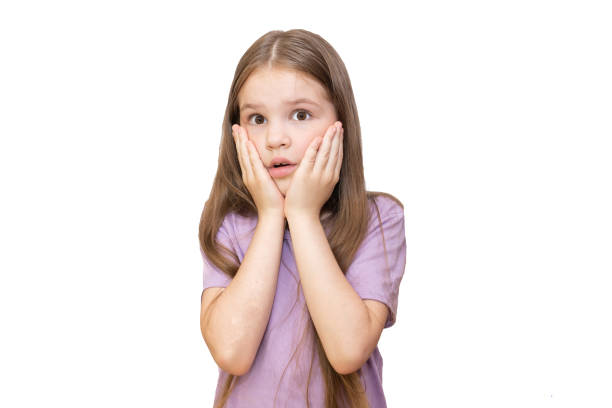 istock Little girl is skeptical looking up. Isolated on a white background. 1168087272