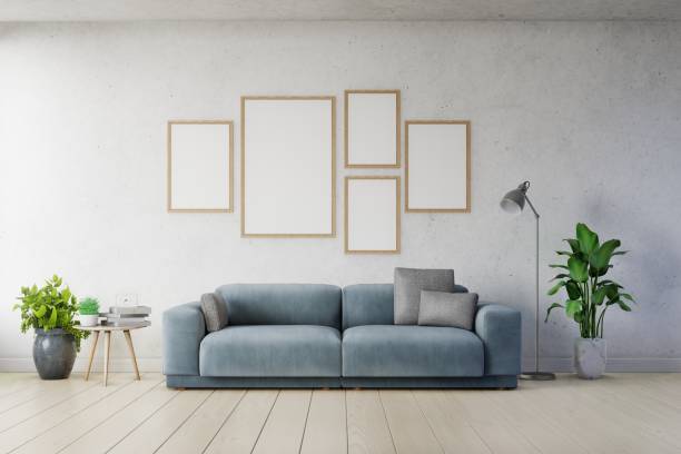 istock Poster mockup with vertical frames on empty white wall in living room interior ad dark blue sofa. 1168087324
