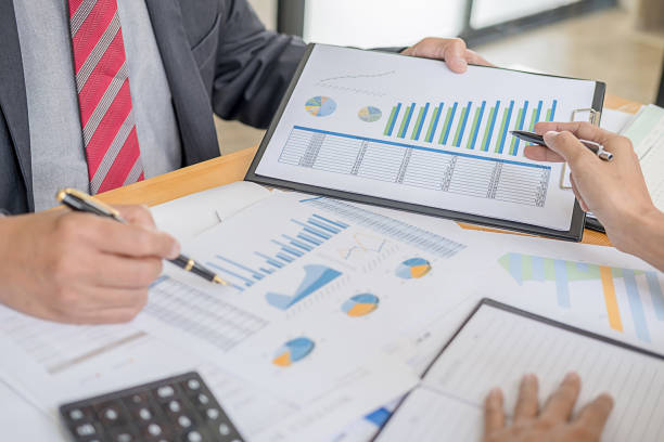 istock Business adviser analyzing financial figures denoting the progress Internal Revenue Service checking document. Audit concept 1168087590