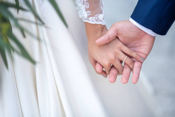 istock Bridegroom holding the hand of his bride 1168089723