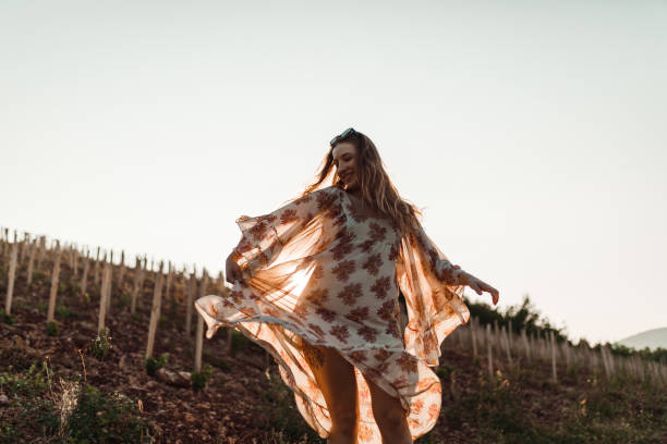 istock Young woman dancing on a sunny day in nature 1168089812