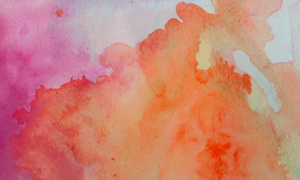 istock Orange and Pink watercolor background on a white paper 1168092898