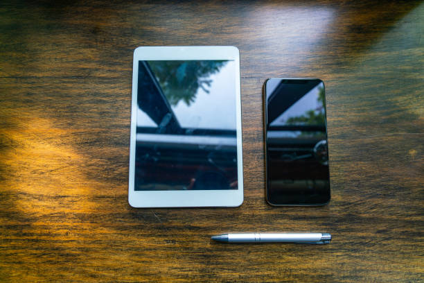 Digital tablet and cellphone on rustic wooden background