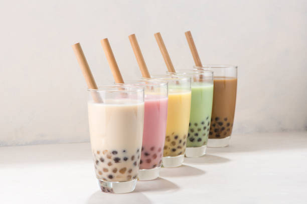 istock Colorful selection of milky fruit flavored bubble tea arranged in a line on white background 1168096774