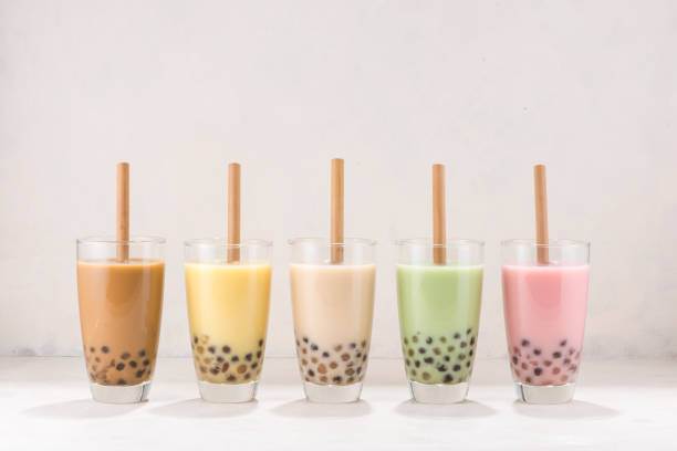 istock Row of fresh boba bubble tea glasses with straw on white background. 1168096816