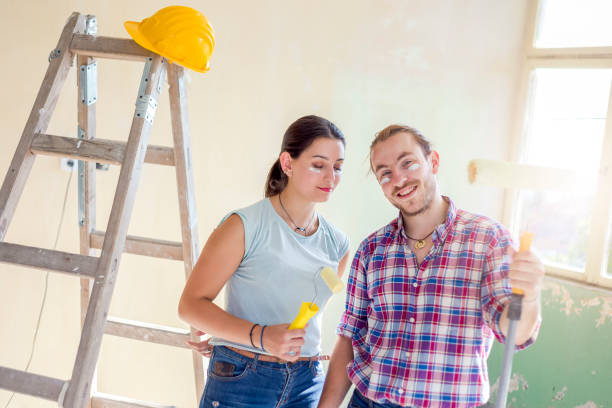 istock Beautiful young couple making redecoration at home 1168105613