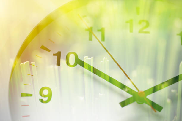 istock Times clock face overlay with green grass nature background. time to saving environment ecology concept 1168107356