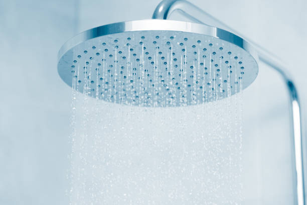 Rain water falling type shower head with blue clean tone Rain water falling type shower head with blue clean tone shower head stock pictures, royalty-free photos & images