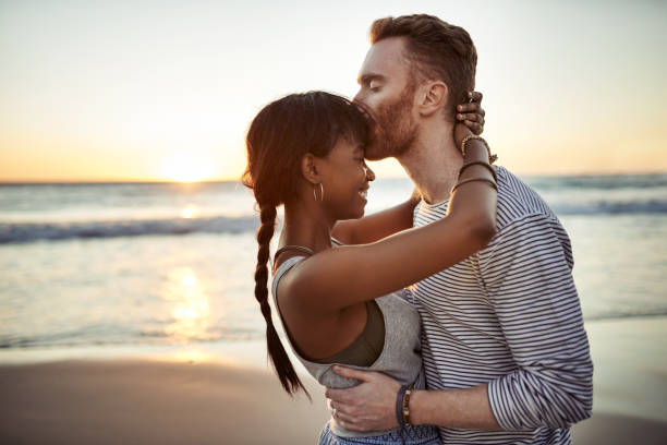 Cropped shot of an affectionate couple spending the day at the beach