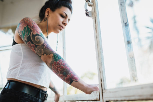 istock Tattooed Latina looking through the window 1168109688