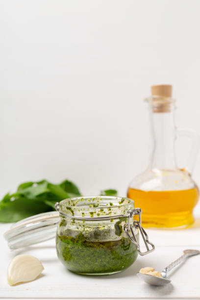 istock Fresh pesto with basil on wooden bsckground 1168113499