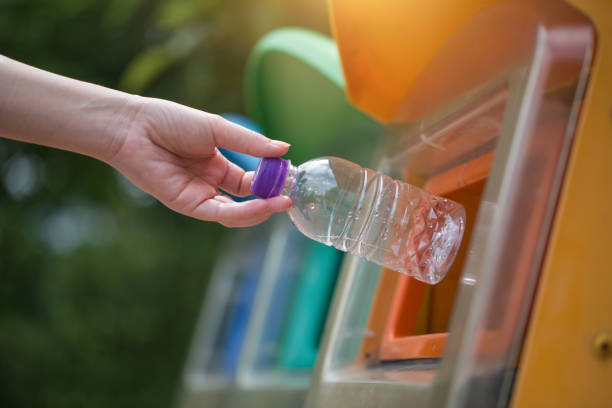 istock Close up hand throwing empty plastic bottle into the trash, recycling concept 1168116008