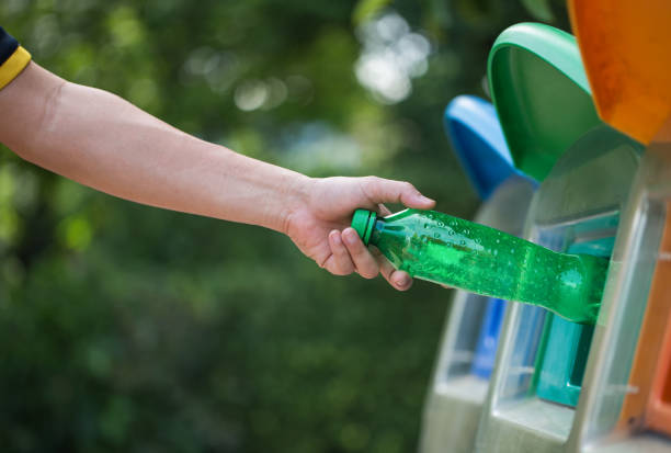 istock Close up hand throwing empty plastic bottle into the trash, recycling concept 1168116009