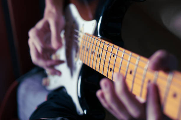 a man playing electric guitar