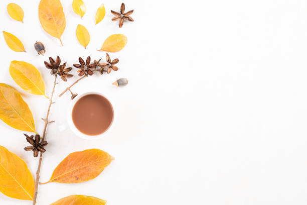 istock Autumn composition. Fallen yellow leaves and branches Cup of coffee on white background. Flat lay, top view copy space. 1168117915