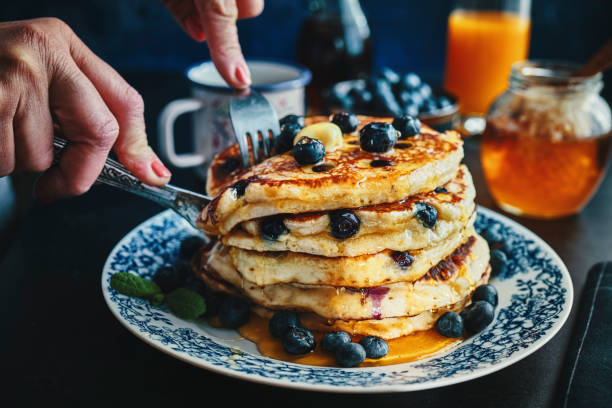 istock Stack of Pancakes with Maple Syrup and Fresh Blueberries 1168118553