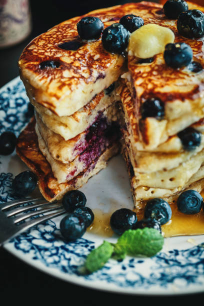 istock Stack of Pancakes with Maple Syrup and Fresh Blueberries 1168118556