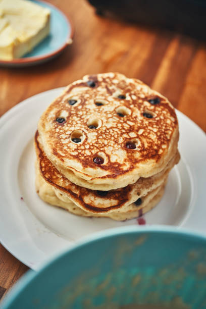 istock Preparing Blueberry Pancakes in a Cooking Pan in Domestic Kitchen 1168118571