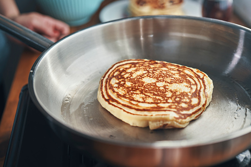 Preparing Pancakes in a Cooking Pan in Domestic Kitchen