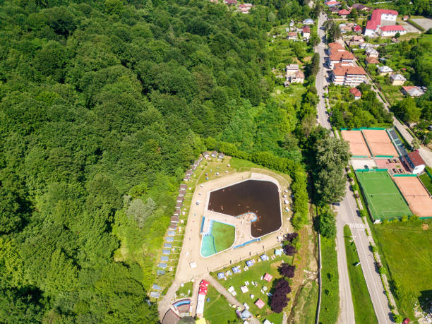 istock Topview from a drone over the pool surrounded by green trees. 1168119658