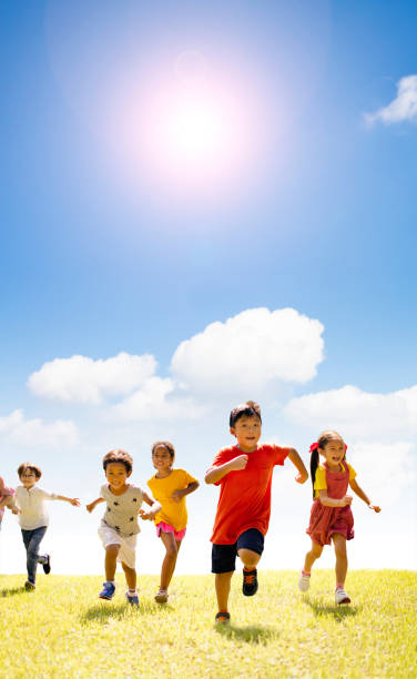 istock Multiethnic group of school children running on the grass 1168121519