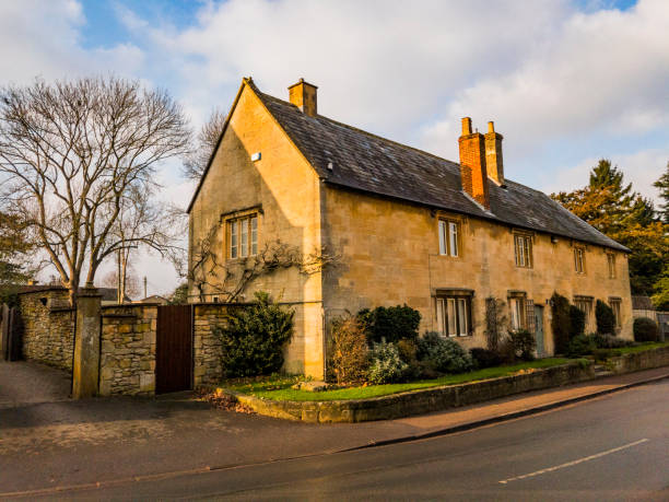 12th. August 2019. Old medieval cottage on the high street of Mickleton Village Gloucestershire. It is a bright warm spring day and there are no recognisable people in the picture.