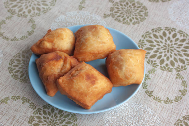 Five delicious fried pies lie on a blue plate