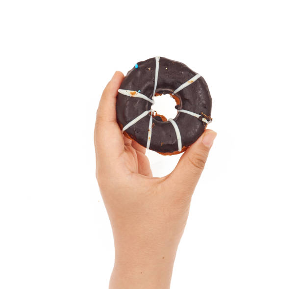 istock Female hand holding Doughnut on a white background 1168125877