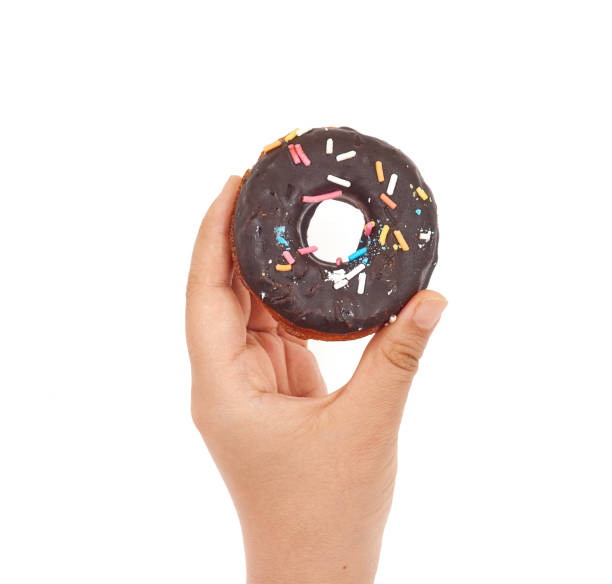 istock Female hand holding Doughnut on a white background 1168125879