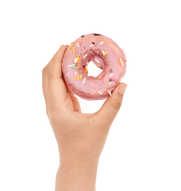 istock Female hand holding Doughnut on a white background 1168125889