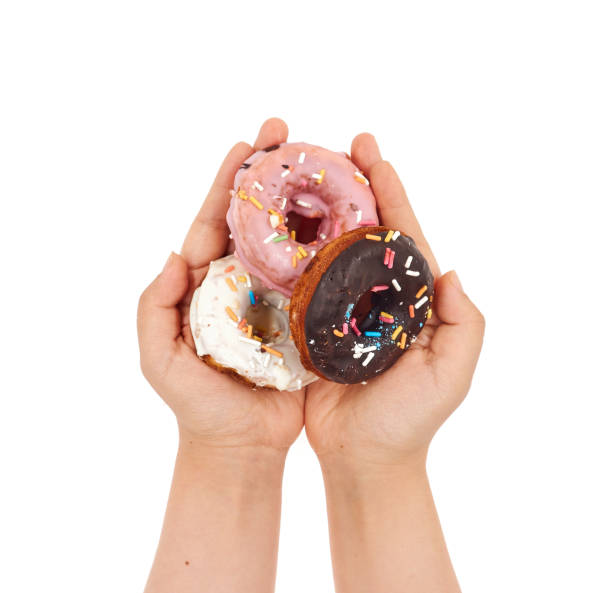 istock Female hand holding Doughnut on a white background 1168125936
