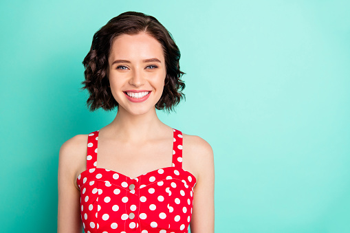 Close up portrait of fascinating young, beautiful wonderful lady posing in front of came while isolated with teal background