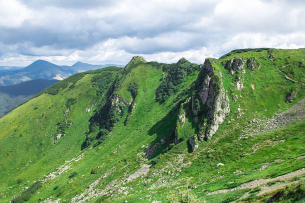 istock green mountain alps ridge, low gray clouds 1168133416