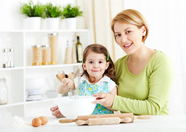 istock Mother and child cooking together 1168135788