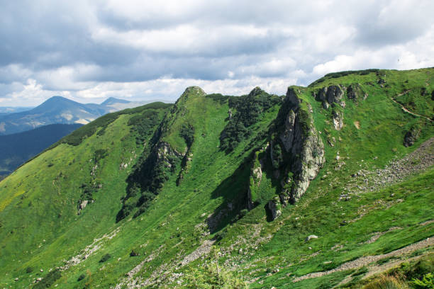istock green mountain alps ridge, low gray clouds 1168136439