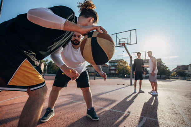 istock Men playing basketball outdoors 1168137457