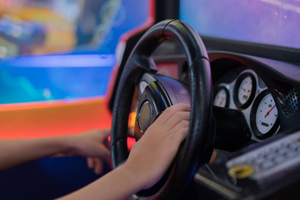 happy boy playingcar racing jeu vidéo - amusement arcade arcade video game sport photos et images de collection