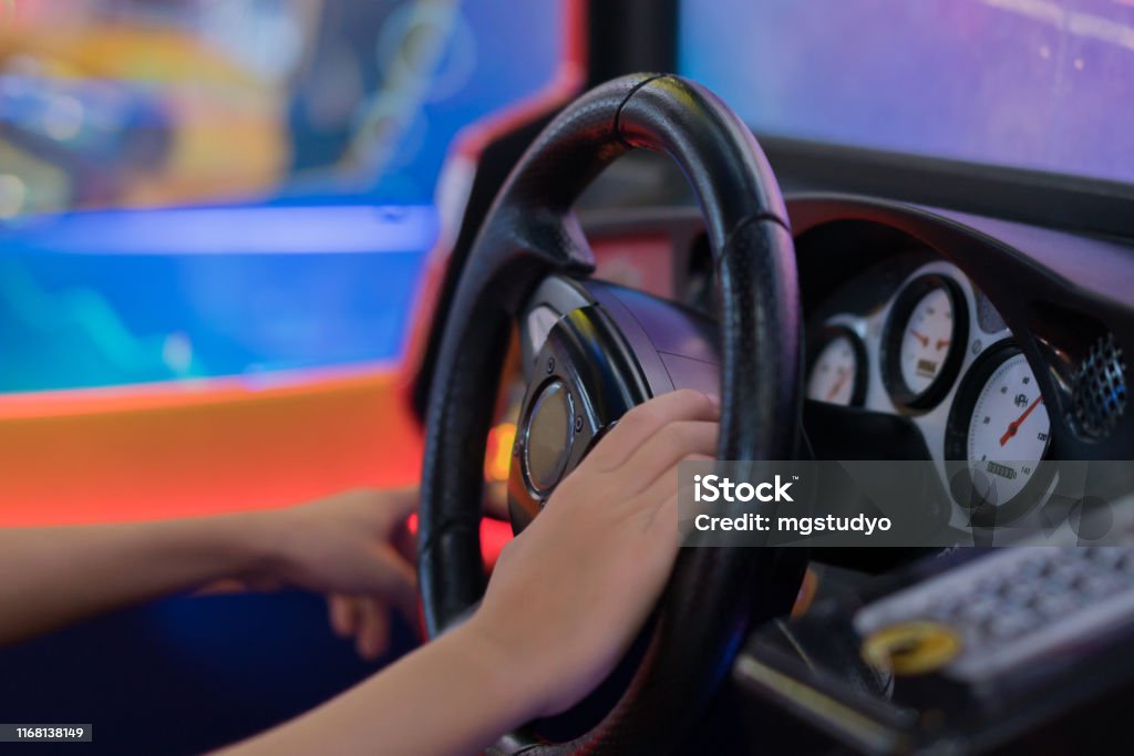 Happy Boy PlayingCar Racing Video Game Amusement Arcade Stock Photo